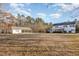 Exterior view of the home, detached garage, and spacious lawn at 69 Holly Tree Dr, Timberlake, NC 27583