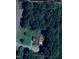 Aerial view of home on a wooded lot surrounded by mature trees at 7098 Blue Springs St, Gibsonville, NC 27249