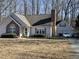 Charming home features an attached garage, chimney, and well-maintained landscaping at 7098 Blue Springs St, Gibsonville, NC 27249