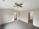 Bedroom with neutral colored carpet and walls, with doors to the ensuite and closet at 7104 Proctor Hill Dr, Raleigh, NC 27613