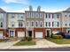 Charming townhome exterior featuring brick accents, attached garages, and manicured landscaping at 7104 Proctor Hill Dr, Raleigh, NC 27613