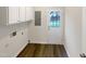 The laundry room has built-in cabinets and a door to the outside at 7104 Proctor Hill Dr, Raleigh, NC 27613