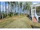 Green backyard with mature trees, providing a serene and private outdoor space at 1013 Timber Mist Ct, Cary, NC 27519