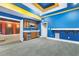 Finished basement with bar, gray carpet, and blue and yellow accent paint at 1013 Timber Mist Ct, Cary, NC 27519