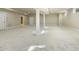 Spacious basement with carpeted floor, support columns, and natural light, offering versatile living space at 1013 Timber Mist Ct, Cary, NC 27519