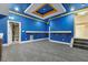Finished basement with gray carpet, storage room, and blue and yellow accent paint at 1013 Timber Mist Ct, Cary, NC 27519