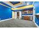 Bright basement with wet bar, blue walls, custom ceiling, and ample space for entertaining and relaxation at 1013 Timber Mist Ct, Cary, NC 27519
