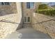 Exterior basement entrance with stairs, brick walls, and a secure door at 1013 Timber Mist Ct, Cary, NC 27519