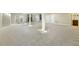 Large finished basement with neutral carpet features white support beams and a separate bathroom at 1013 Timber Mist Ct, Cary, NC 27519