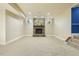 Spacious basement features a stone fireplace and a blue stairwell with neutral walls and carpet at 1013 Timber Mist Ct, Cary, NC 27519