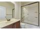 Bathroom featuring a shower over bath, a brown vanity cabinet with a sink and a mirror on the wall at 1013 Timber Mist Ct, Cary, NC 27519
