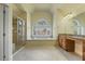 Bright bathroom with a walk-in shower, tiled flooring, and soaking tub under a large window at 1013 Timber Mist Ct, Cary, NC 27519