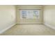 Spacious bedroom with neutral walls and carpet features bright lighting from the large window at 1013 Timber Mist Ct, Cary, NC 27519