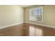 Sunny bedroom features wood floors, a large window, and neutral paint at 1013 Timber Mist Ct, Cary, NC 27519