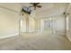 Bright bedroom with carpet, TV, windows with blinds and columns leading to a seating area at 1013 Timber Mist Ct, Cary, NC 27519