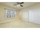 Spacious carpeted bedroom with a window, neutral paint, and sliding closet doors at 1013 Timber Mist Ct, Cary, NC 27519