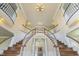 View of a large foyer with a dual staircase, high ceilings, and elegant chandelier at 1013 Timber Mist Ct, Cary, NC 27519