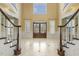 A grand foyer with marble floors, double staircase and elegant finishes at 1013 Timber Mist Ct, Cary, NC 27519