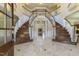 A grand foyer with marble floors, a dual staircase and elegant finishes at 1013 Timber Mist Ct, Cary, NC 27519