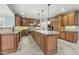 Spacious gourmet kitchen with custom cabinets, a center island, and stainless steel appliances at 1013 Timber Mist Ct, Cary, NC 27519