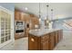 Gourmet kitchen with a large center island, stainless steel appliances, and custom wood cabinetry at 1013 Timber Mist Ct, Cary, NC 27519