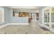 View of open kitchen with island and adjacent hall with access to outdoor patio at 1013 Timber Mist Ct, Cary, NC 27519