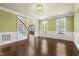 Elegant living room with hardwood floors, wainscoting, and an open view to the foyer at 1013 Timber Mist Ct, Cary, NC 27519