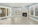 View of the fireplace in the living room with access to the patio through the sliding glass door at 1013 Timber Mist Ct, Cary, NC 27519