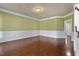 Living room showcasing wainscoting detail and rich hardwood floors at 1013 Timber Mist Ct, Cary, NC 27519