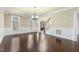 Bright living room with hardwood floors, wainscoting, and a glimpse of the foyer at 1013 Timber Mist Ct, Cary, NC 27519