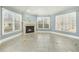 Inviting living room with fireplace, bright windows with wood blinds, and tile flooring at 1013 Timber Mist Ct, Cary, NC 27519