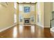 Spacious living room boasts hardwood floors, a stone fireplace, and abundant natural light from large windows at 1013 Timber Mist Ct, Cary, NC 27519