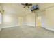 Spacious main bedroom featuring a ceiling fan, TV, and multiple entryways at 1013 Timber Mist Ct, Cary, NC 27519