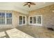 Covered patio area features brick walls, tile floors, and a ceiling fan for outdoor comfort at 1013 Timber Mist Ct, Cary, NC 27519