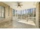 Relaxing screened porch with brick accents and a ceiling fan overlooking backyard at 1013 Timber Mist Ct, Cary, NC 27519