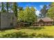 Sprawling backyard with mature trees, two decks and covered parking at 1031 Wait Ave, Wake Forest, NC 27587