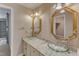 Bathroom featuring glass vessel sinks, granite counters, and vintage lighting fixtures above the mirrors at 1031 Wait Ave, Wake Forest, NC 27587