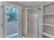 Bathroom features shower with glass door, door to outdoor area, and built in shelves at 1031 Wait Ave, Wake Forest, NC 27587