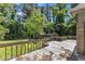 View from a large deck overlooking the backyard featuring mature trees and a glimpse of the home at 1031 Wait Ave, Wake Forest, NC 27587