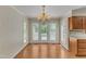 Inviting dining area with chandelier and access to a backyard deck at 1031 Wait Ave, Wake Forest, NC 27587