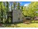 Exterior of home showing a small second story deck, surrounding trees, and a covered carport at 1031 Wait Ave, Wake Forest, NC 27587