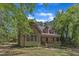Charming cabin-style home with a cozy front porch nestled among the trees at 1031 Wait Ave, Wake Forest, NC 27587