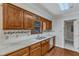 Kitchen with wood cabinets, granite countertops, and stainless steel dishwasher at 1031 Wait Ave, Wake Forest, NC 27587