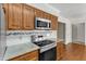 This kitchen features stainless steel appliances, granite countertops, and wood cabinets at 1031 Wait Ave, Wake Forest, NC 27587