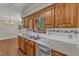This kitchen features a stainless steel dishwasher, granite countertops, and wood cabinets at 1031 Wait Ave, Wake Forest, NC 27587