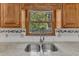 This kitchen features a stainless steel sink, granite countertops, wood cabinets, and a window with a view at 1031 Wait Ave, Wake Forest, NC 27587