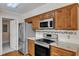 Modern kitchen featuring stainless steel appliances and stylish wood cabinetry at 1031 Wait Ave, Wake Forest, NC 27587
