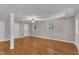 Bright living room features hardwood floors, a ceiling fan, and ample natural light from the windows at 1031 Wait Ave, Wake Forest, NC 27587