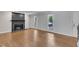 Sun-filled living room with hardwood floors and a cozy traditional fireplace at 1031 Wait Ave, Wake Forest, NC 27587