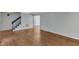Spacious living room with hardwood floors, light grey walls, and a staircase at 1031 Wait Ave, Wake Forest, NC 27587